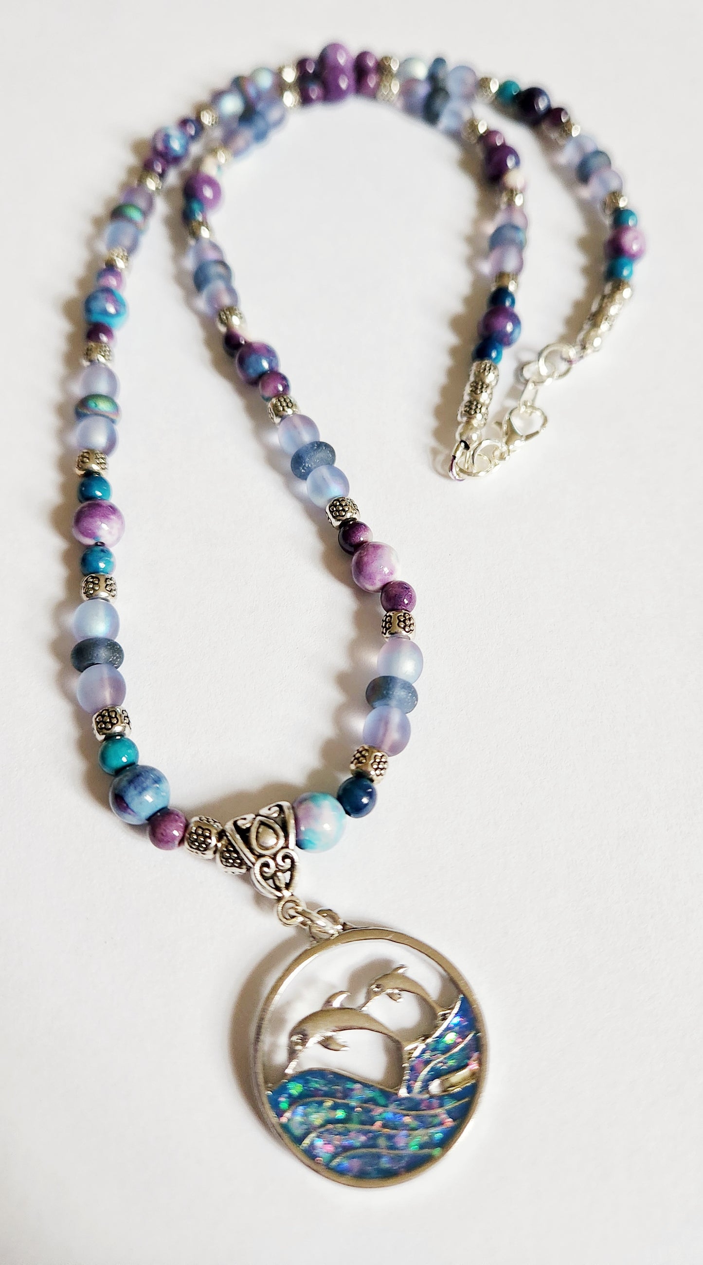 Silver dolphin and wave gemstone necklace