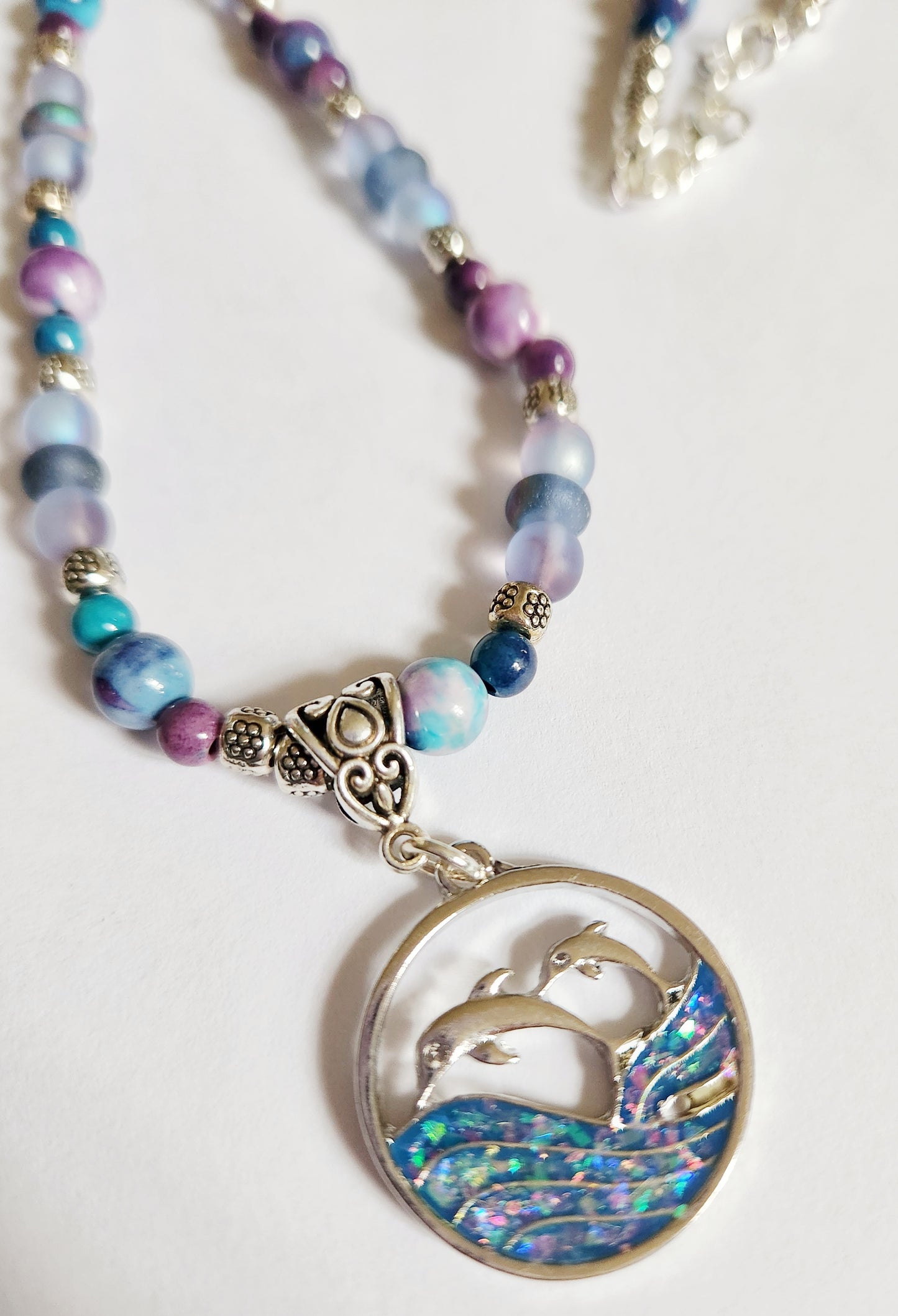 Silver dolphin and wave gemstone necklace
