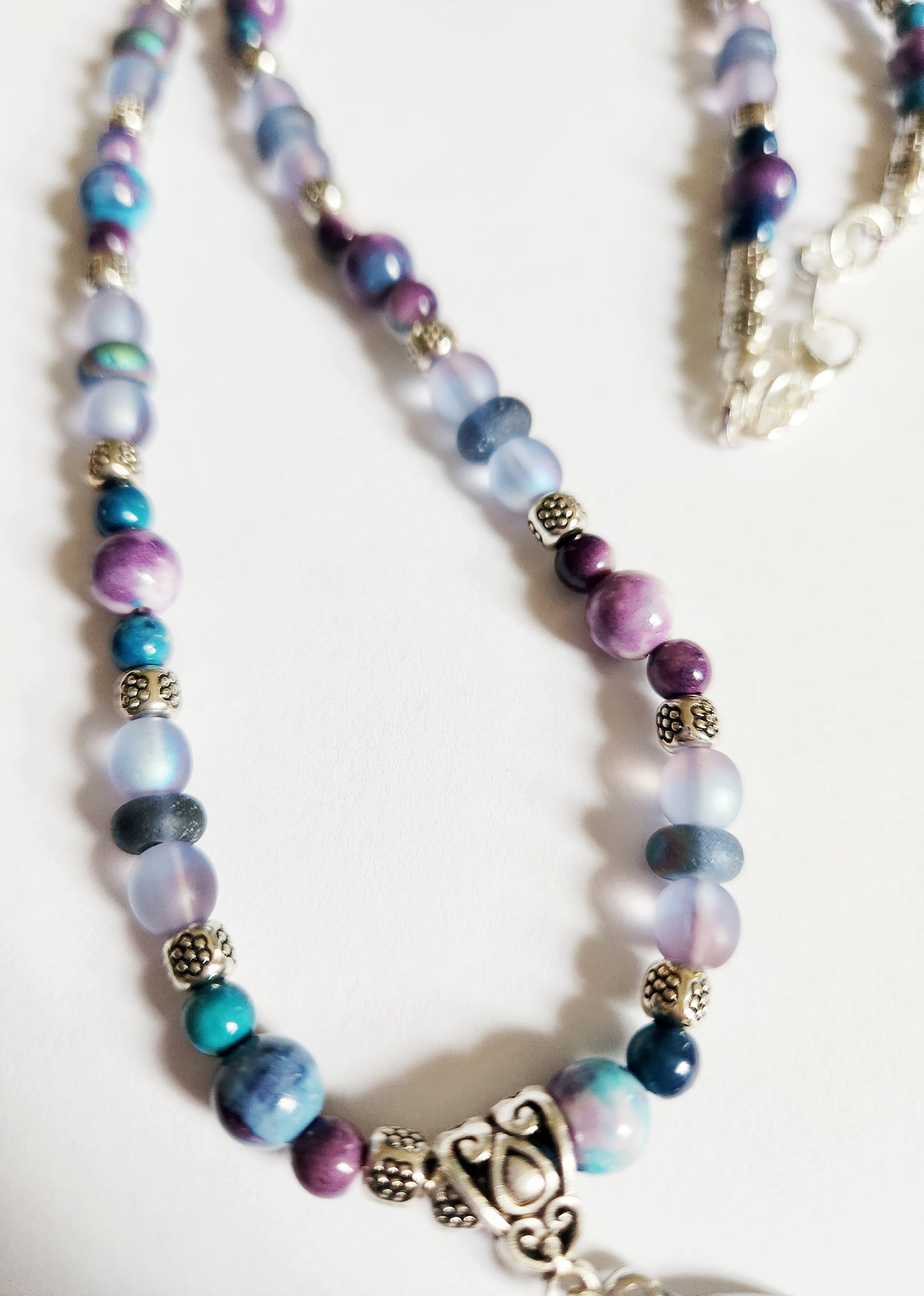 Silver dolphin and wave gemstone necklace