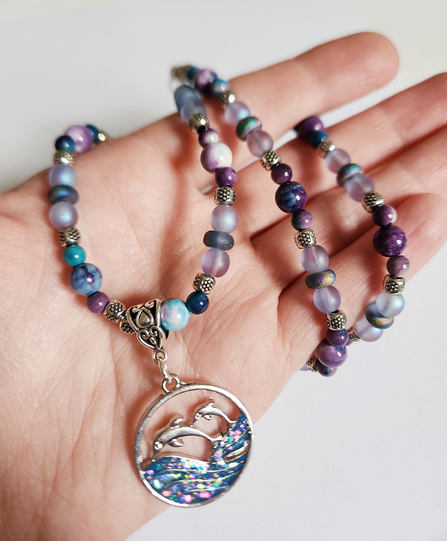 Silver dolphin and wave gemstone necklace