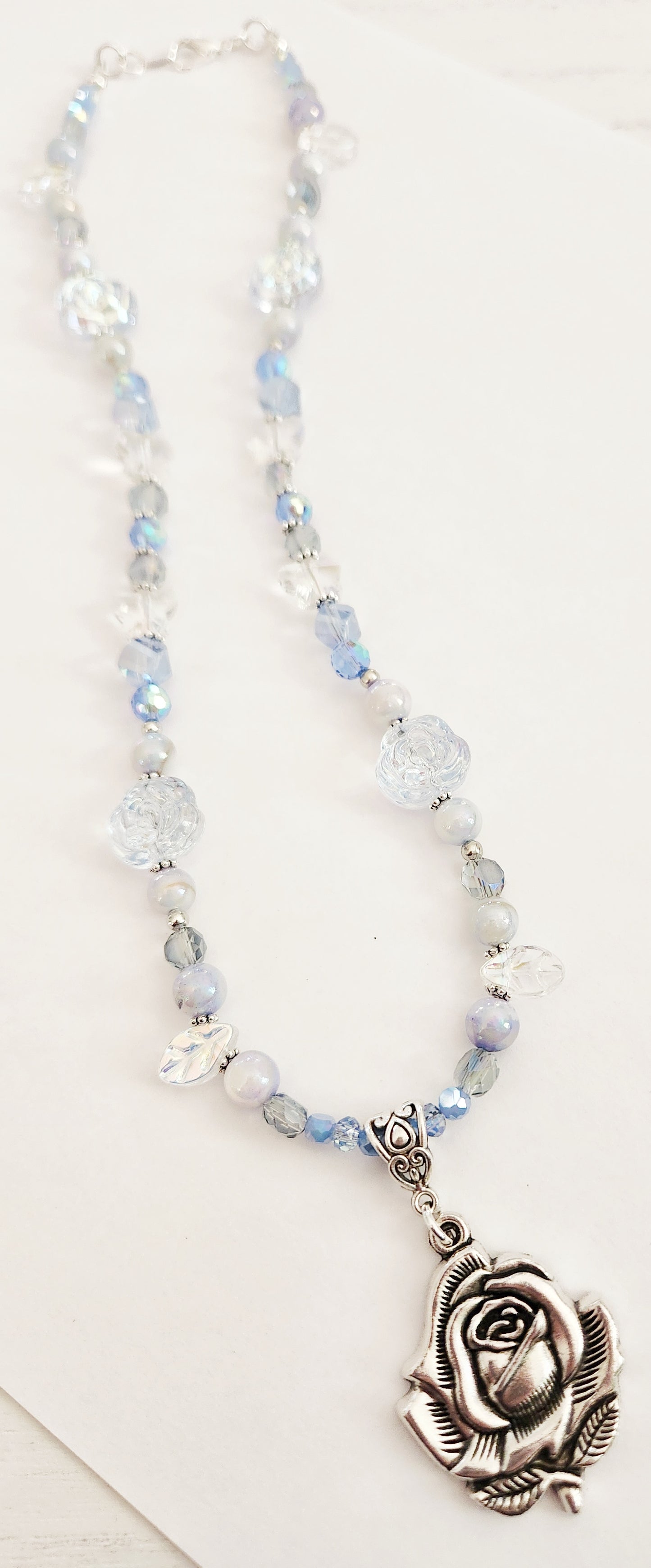 Silver rose and blue whimsical gemstone necklace