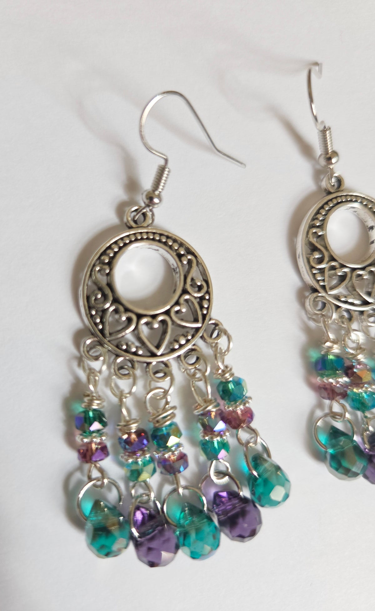 Silver heart chandelier earrings with purple and green beads