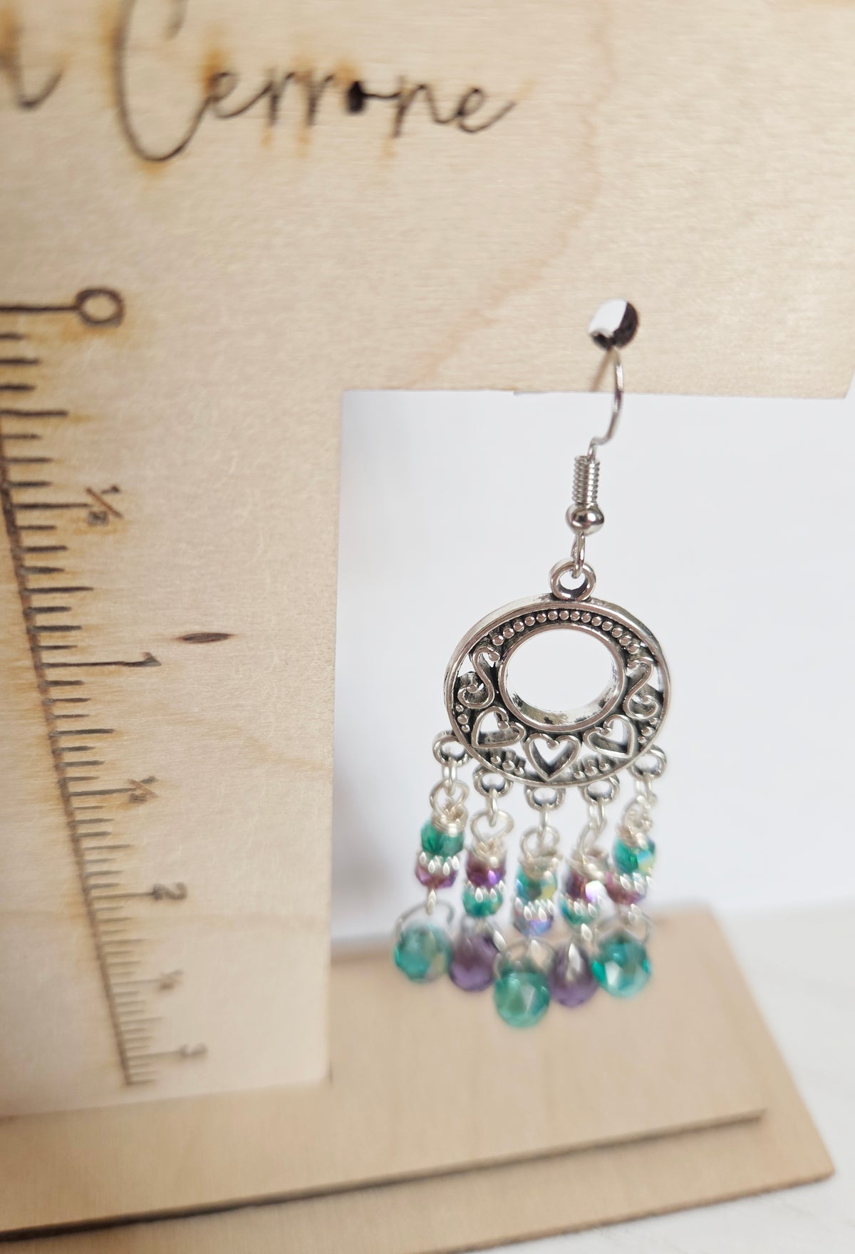 Silver heart chandelier earrings with purple and green beads